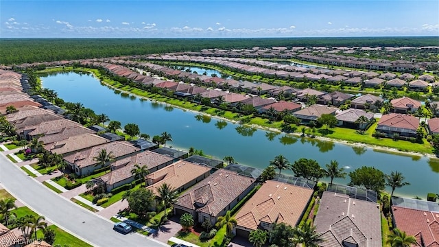 drone / aerial view featuring a water view and a residential view