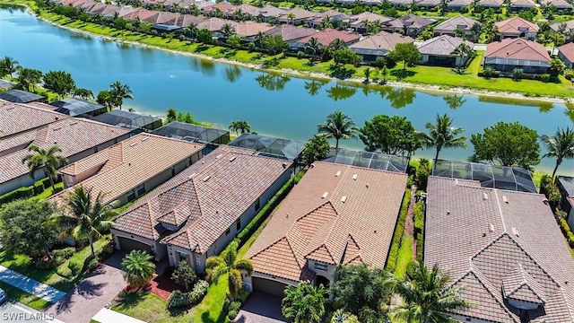 drone / aerial view with a water view and a residential view
