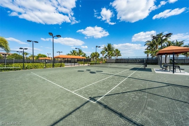 view of sport court featuring a gazebo and fence