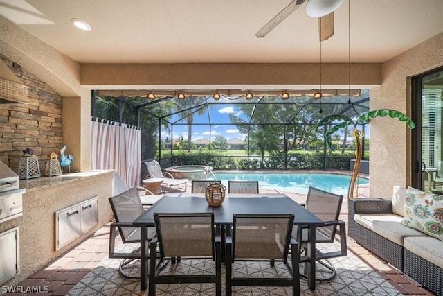 view of patio with outdoor dining area, an outdoor hangout area, an outdoor kitchen, a fenced in pool, and a ceiling fan