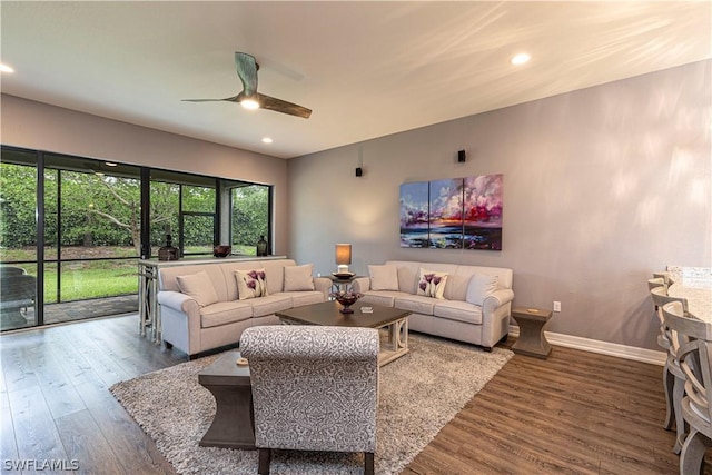 living room featuring hardwood / wood-style floors and ceiling fan