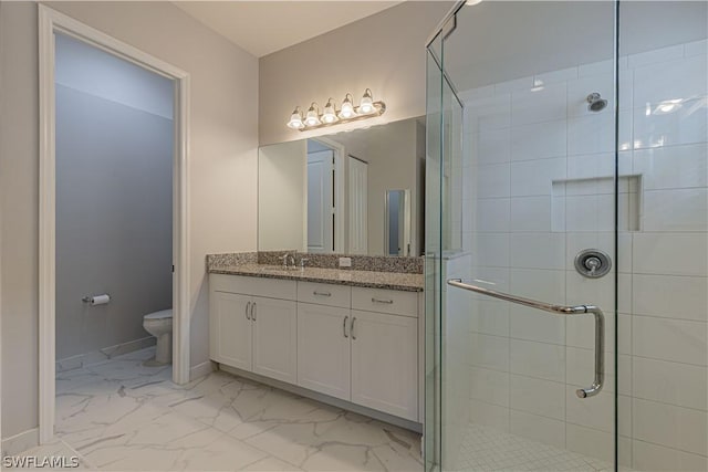 bathroom featuring vanity, toilet, and walk in shower