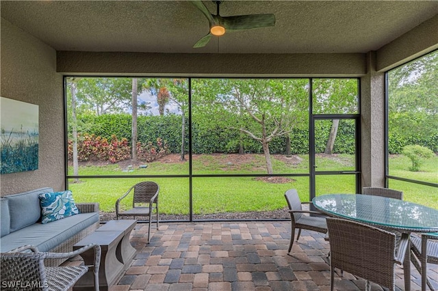 sunroom featuring ceiling fan