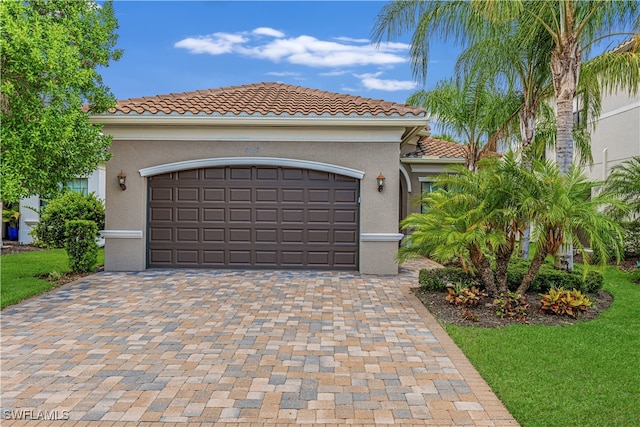 mediterranean / spanish house with a garage