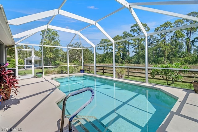 view of pool featuring a patio and glass enclosure