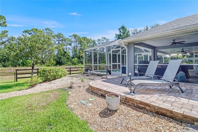 view of yard with a lanai, a patio area, and ceiling fan