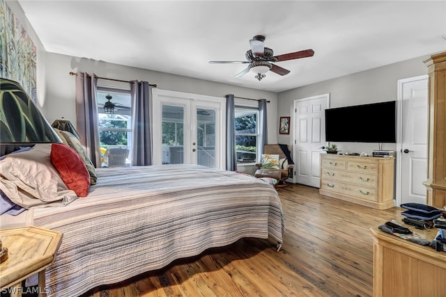 bedroom featuring french doors, wood-type flooring, ceiling fan, and access to exterior