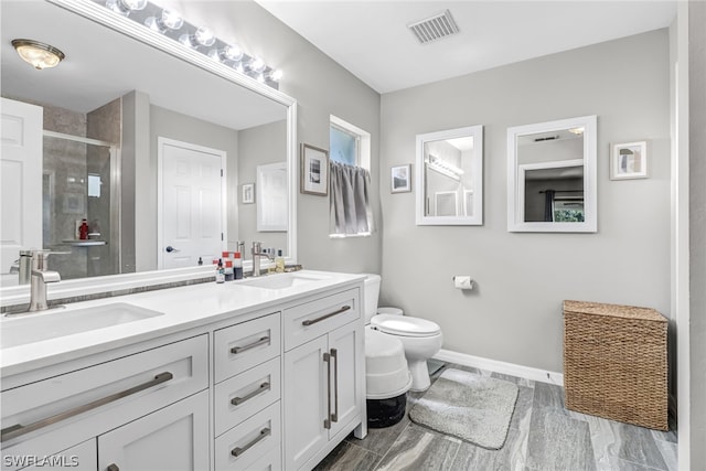 bathroom with tile patterned floors, toilet, and dual bowl vanity