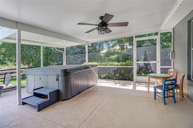 sunroom / solarium with a healthy amount of sunlight and ceiling fan