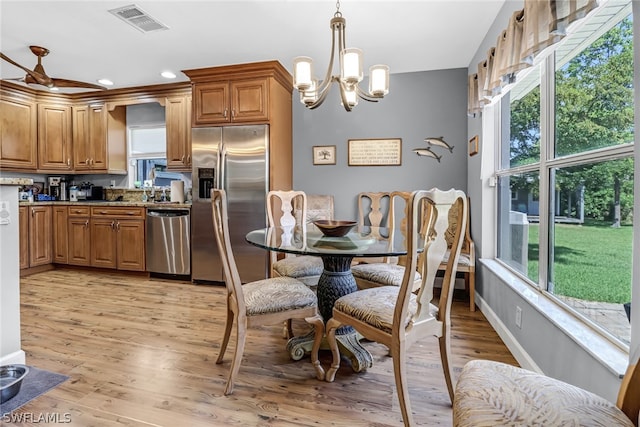 dining room featuring an inviting chandelier and light wood-type flooring