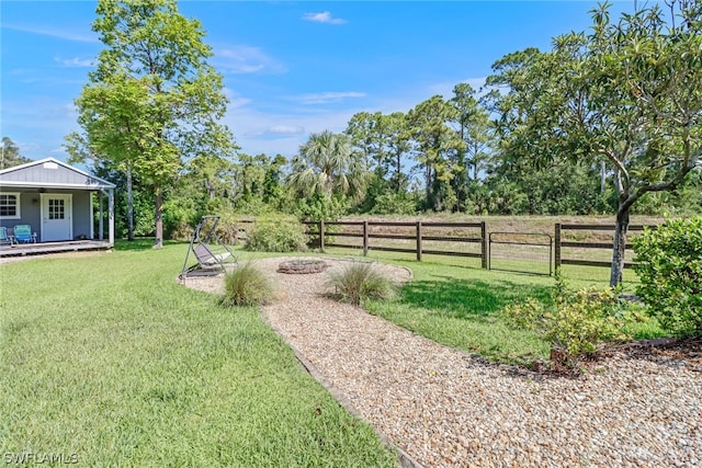 view of yard featuring a fire pit and a rural view