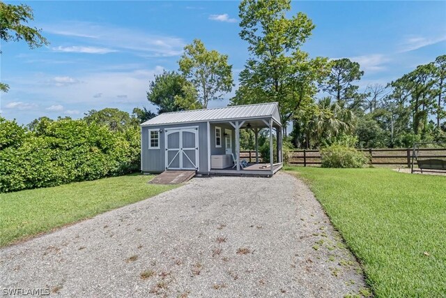 exterior space with a front lawn and an outdoor structure