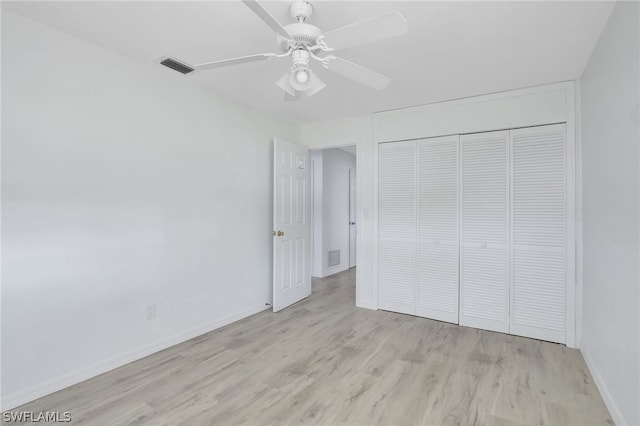 unfurnished bedroom featuring ceiling fan, a closet, and light hardwood / wood-style flooring