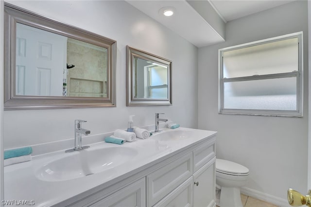 bathroom featuring tile patterned floors, vanity, and toilet