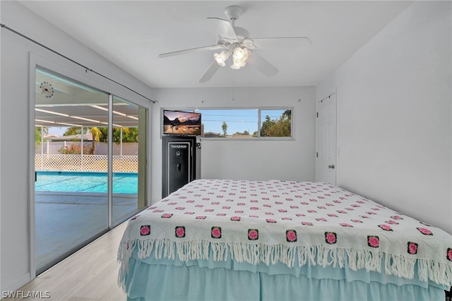 bedroom with ceiling fan, wood-type flooring, and access to outside