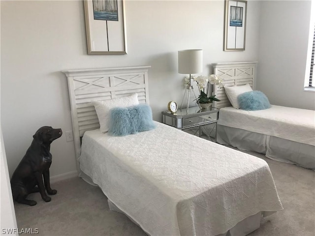 bedroom featuring light carpet