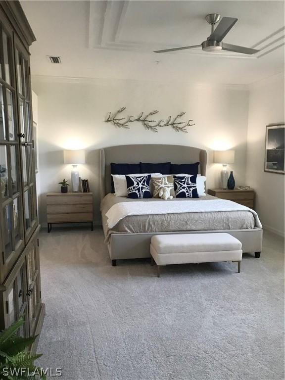 carpeted bedroom featuring ceiling fan and ornamental molding