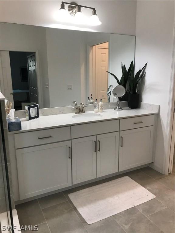 bathroom with tile patterned floors and vanity