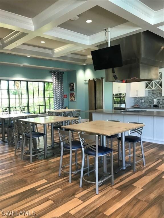 kitchen featuring white cabinets, coffered ceiling, hardwood / wood-style flooring, and tasteful backsplash