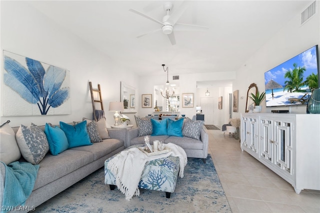 living room with ceiling fan with notable chandelier and light tile flooring