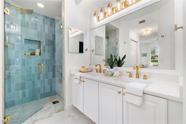 bathroom with vanity and a shower with door