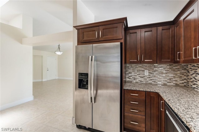 kitchen featuring appliances with stainless steel finishes, decorative backsplash, dark brown cabinets, and light stone counters