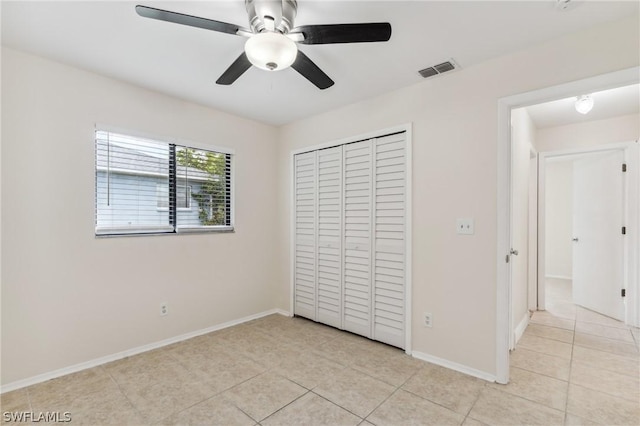 unfurnished bedroom with ceiling fan, light tile patterned flooring, and a closet