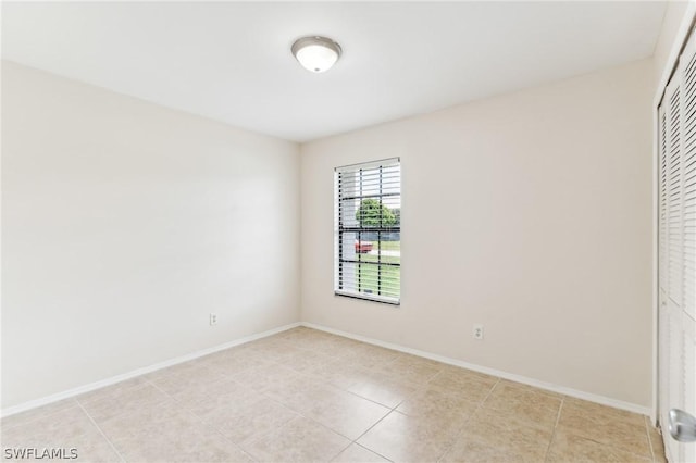 spare room featuring light tile patterned flooring