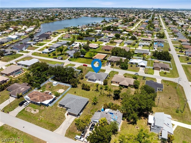 bird's eye view featuring a water view and a residential view