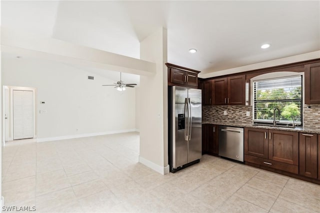 kitchen featuring ceiling fan, decorative backsplash, appliances with stainless steel finishes, and sink