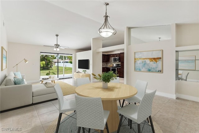 dining space featuring ceiling fan and light tile patterned floors