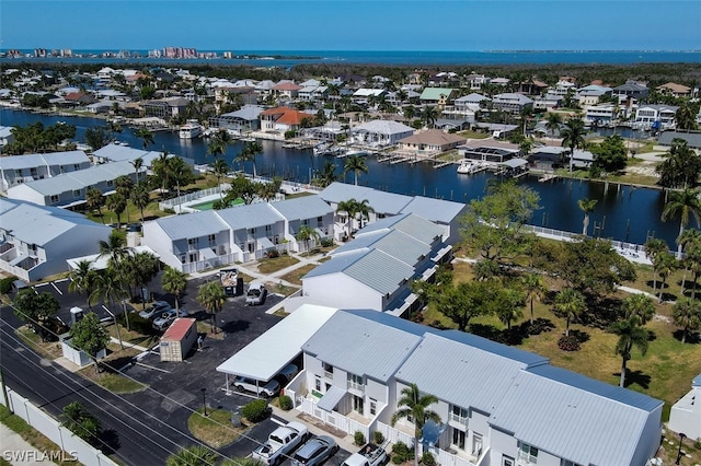 birds eye view of property with a water view and a residential view