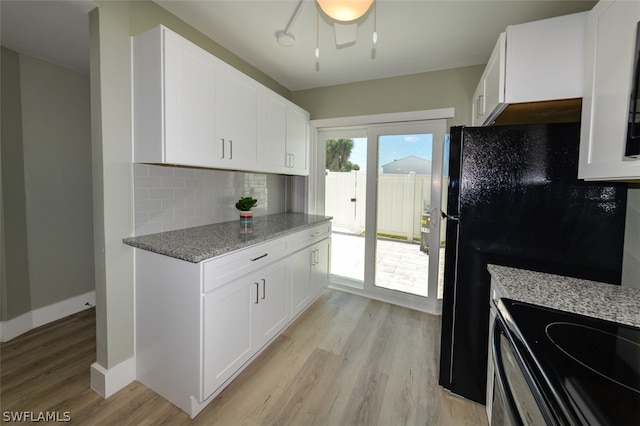 kitchen featuring light hardwood / wood-style floors, light stone countertops, white cabinetry, and tasteful backsplash