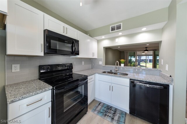 kitchen featuring white cabinetry, sink, ceiling fan, black appliances, and light wood-type flooring