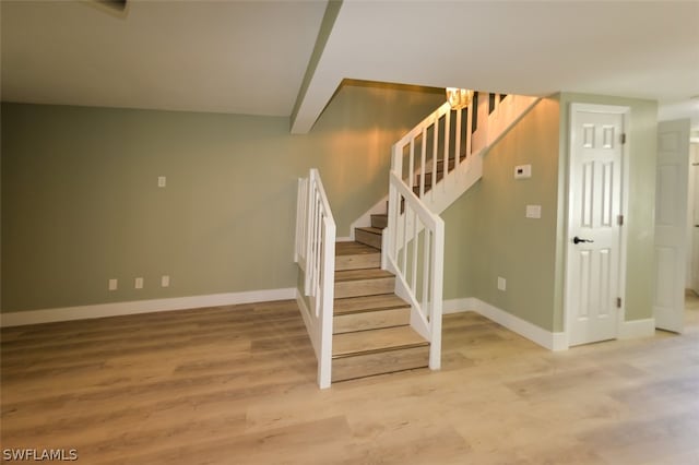 stairway featuring hardwood / wood-style flooring