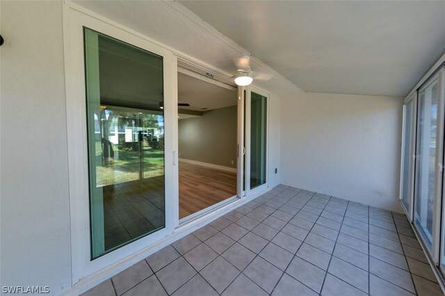 unfurnished sunroom with ceiling fan