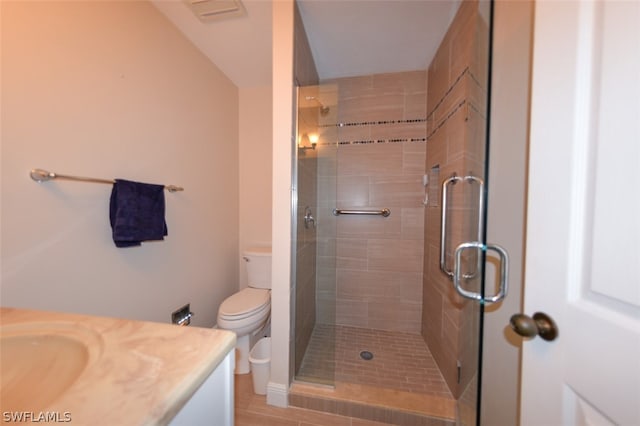 bathroom featuring a shower with door, vanity, and toilet