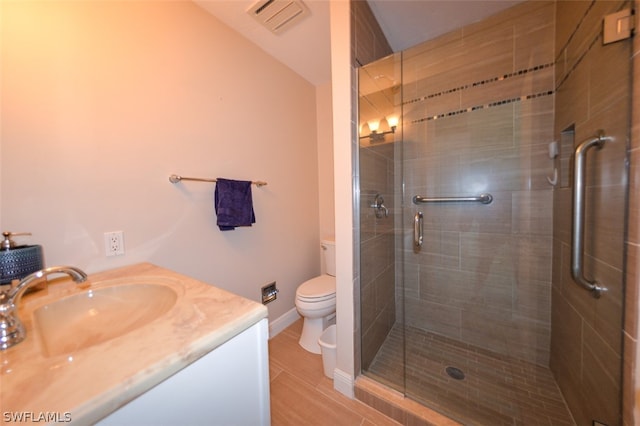 bathroom with toilet, a shower stall, visible vents, and vanity