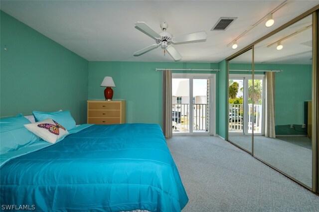 carpeted bedroom featuring rail lighting, access to outside, and ceiling fan