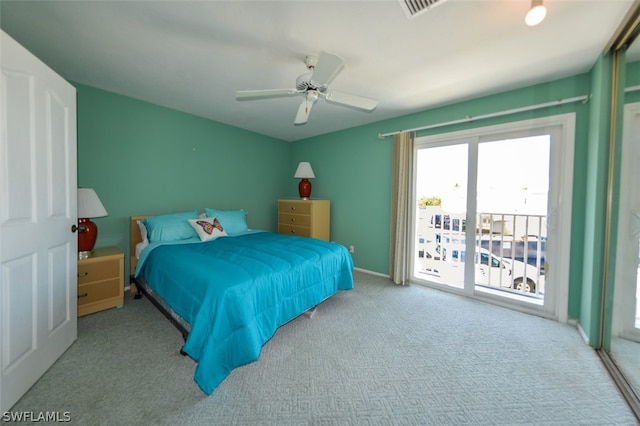 carpeted bedroom featuring baseboards, access to outside, visible vents, and a ceiling fan