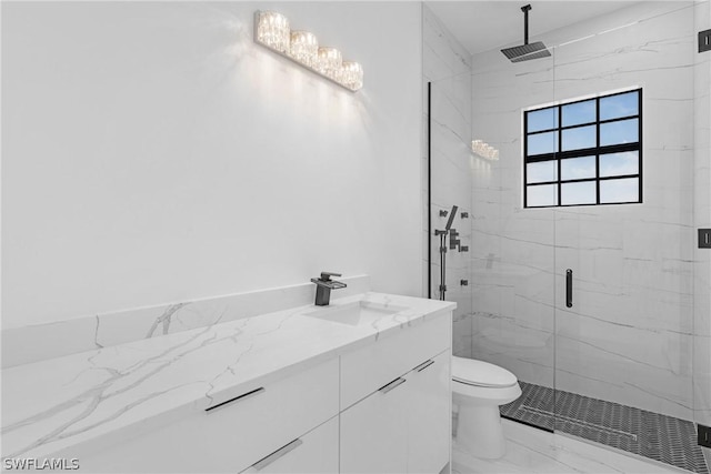 bathroom with vanity, toilet, a shower with shower door, and a chandelier