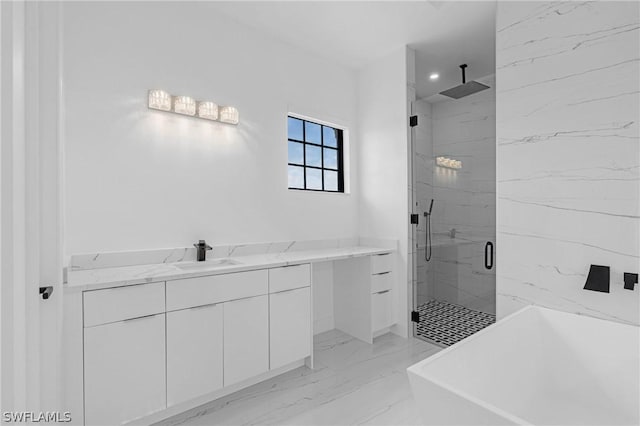 bathroom featuring vanity and independent shower and bath