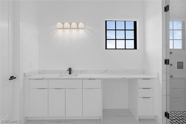 bathroom with vanity and a shower with door