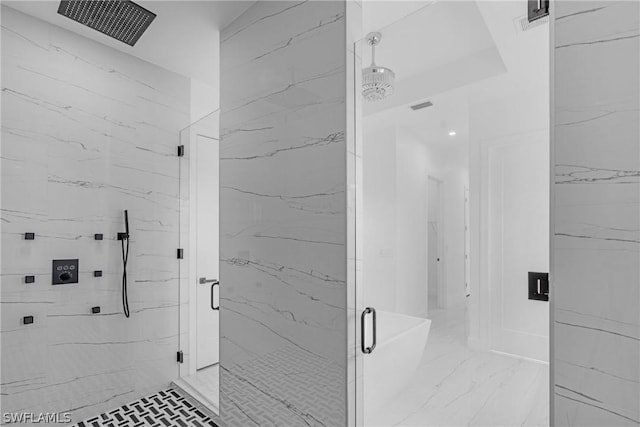 bathroom featuring a shower with shower door