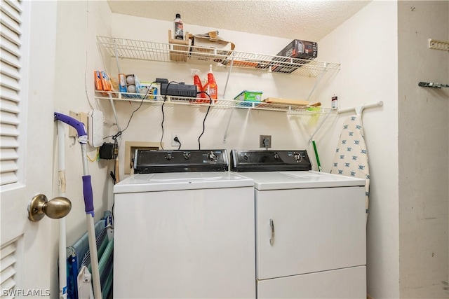 laundry area featuring independent washer and dryer and a textured ceiling