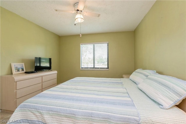 bedroom with a textured ceiling and ceiling fan