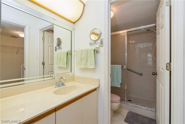 bathroom with toilet, a shower with shower door, and vanity