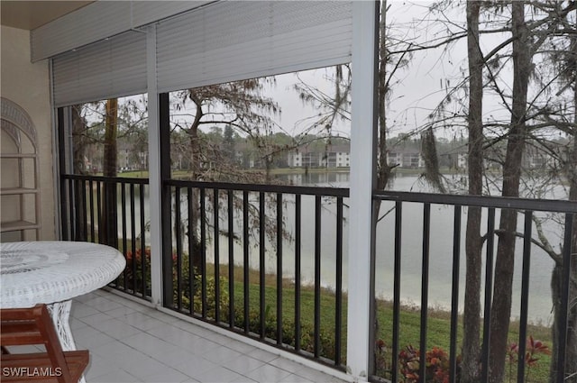 unfurnished sunroom featuring a water view and a healthy amount of sunlight