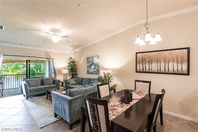 dining space with light tile patterned flooring, ceiling fan with notable chandelier, and ornamental molding