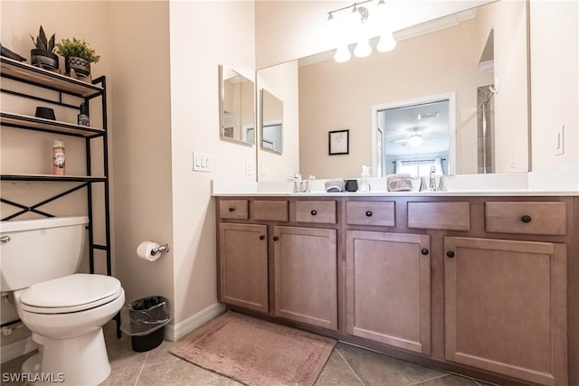 bathroom featuring tile patterned flooring, vanity, and toilet